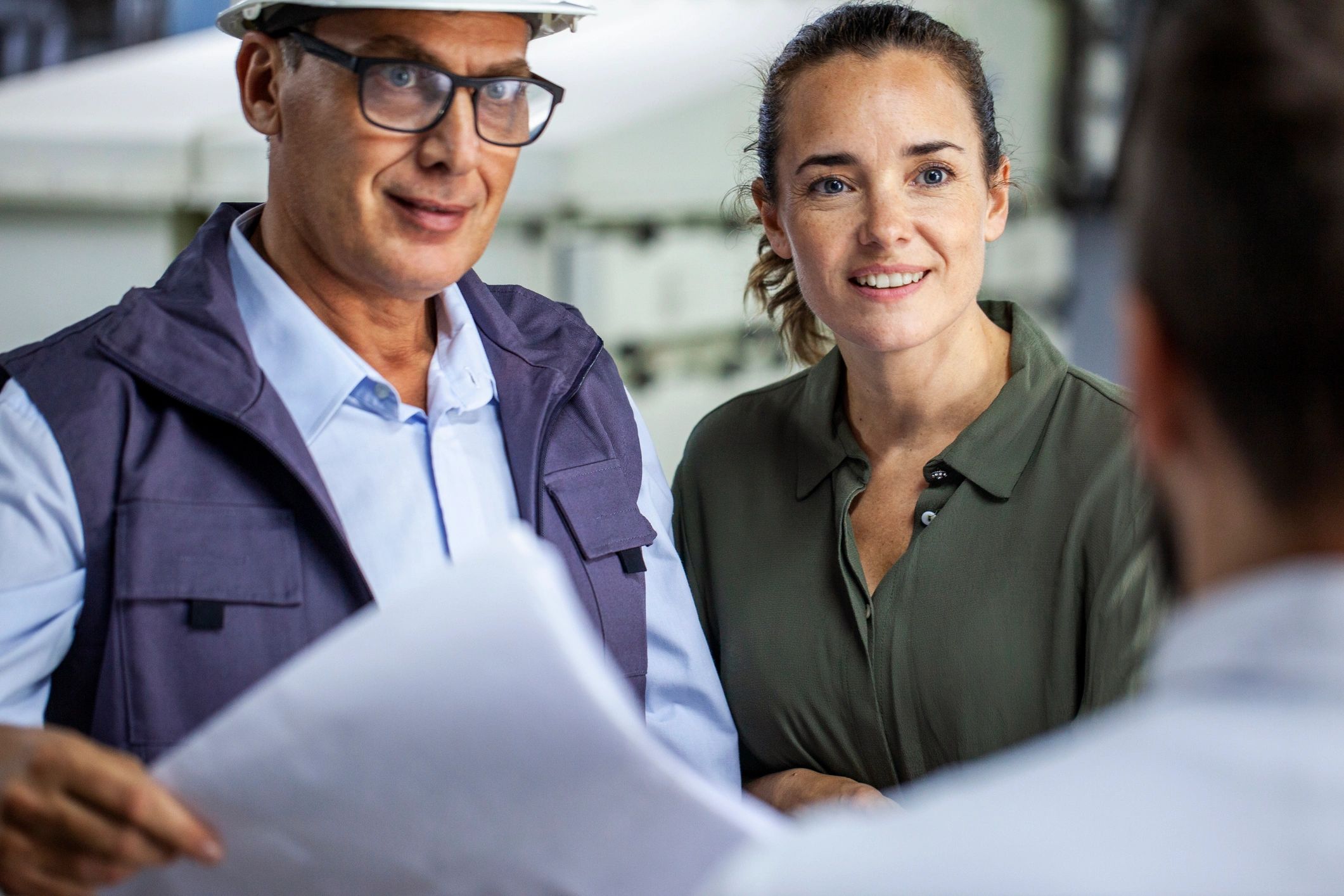Contractor and manager reviewing plans together